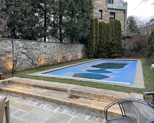 Salvaged granite curb steps installed for entry to the pool