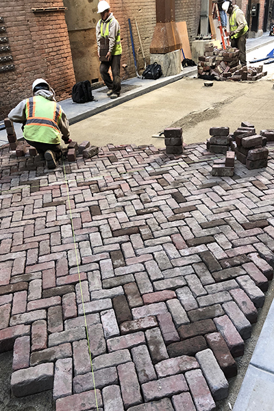 Herringbone pattern installation of salvaged Jamestown rustic bricks