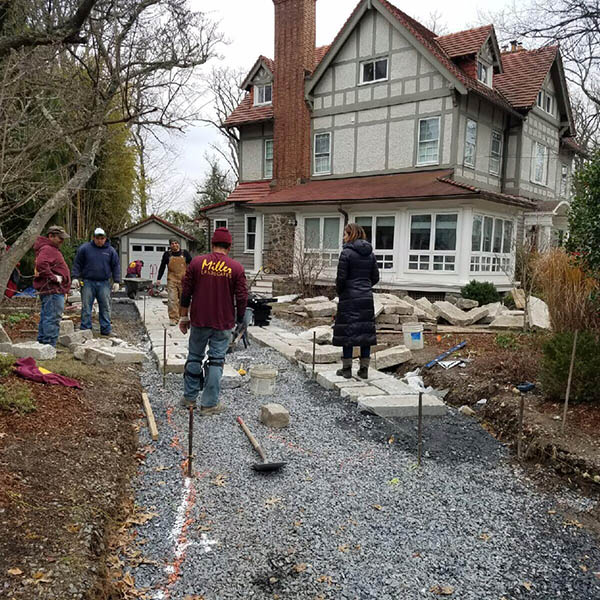 Compacted stone base beneath the reclaimed granite curb driveway