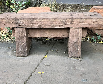 Reclaimed medina sandstone curb bench along rustic walkway