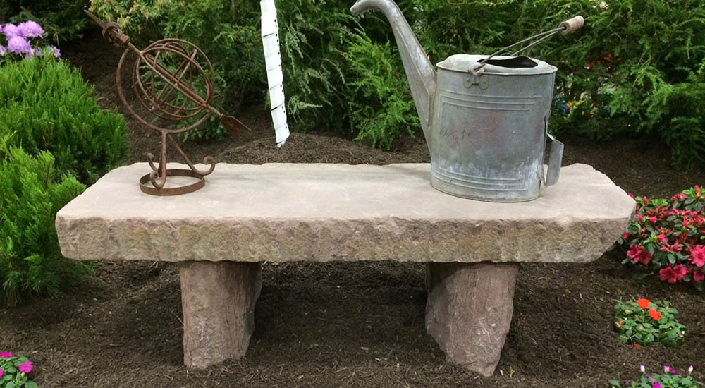 Salvaged medina sandstone curbing installed in garden as relaxing bench