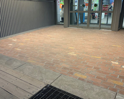 Business entryway adds historic value by using reclaimed Canalside Red cobblestone.