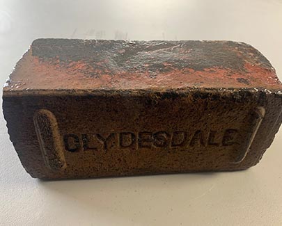 The Clydesdale Brick has a lot of character, as seen by the stamp on the side between spacer bars and the incredibly antique color range on top of the reclaimed brick