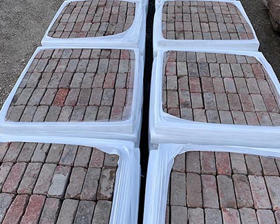 Pallets of this reclaimed brick material line our yard, ready for your next one-of-a-kind hardscape brick project