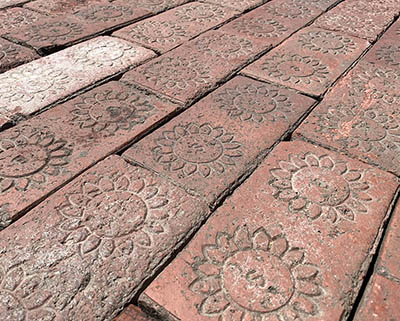 Closer look at the antique stamped sidewalk brick paver, dry application.