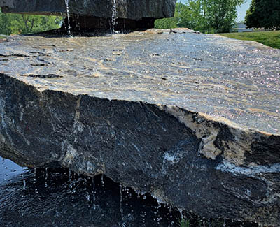 Two-tier waterfall landscape feature for outdoor living space
