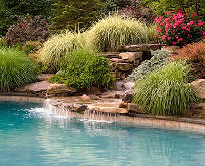 Landscape water feature next to pool