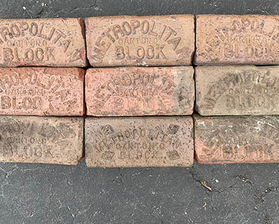 Detailed look at the Metropolitan Block stamp on historic street brick paver