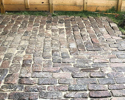 Reclaimed, historic Peacebridge cobblestones installed in backyard patio