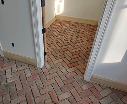 Before whitewashing, our reclaimed Jamestown Rustic street bricks cut down to a floor tile