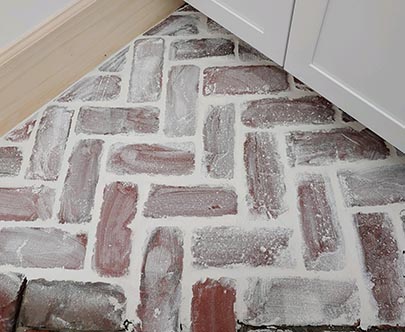 After whitewash application, a desirable look for antique brick flooring