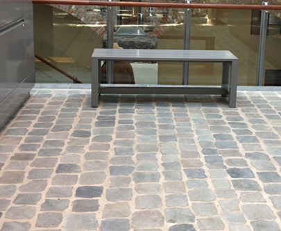 Reclaimed cobblestones installed as floor tiles for an office waiting room.