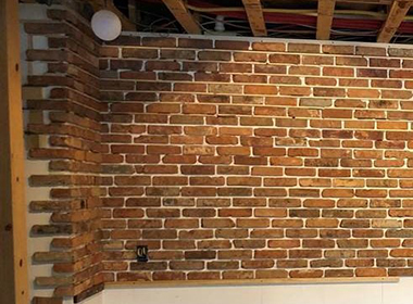 Our reclaimed building brick corner veneer installed in basement project.