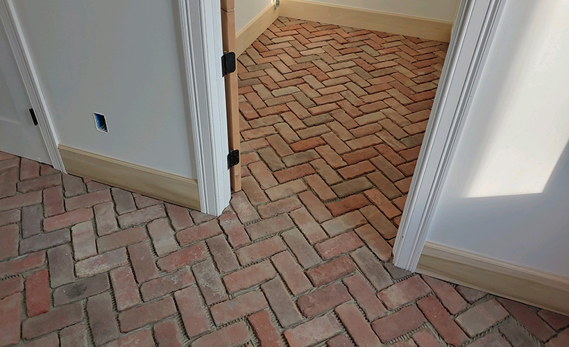 Jamestown Rustic street bricks pavers cut down to floor tiles, installed in a herringbone pattern.